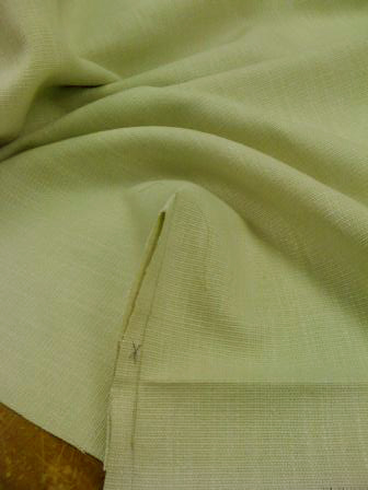 Corner of fabric sewn and with X marked